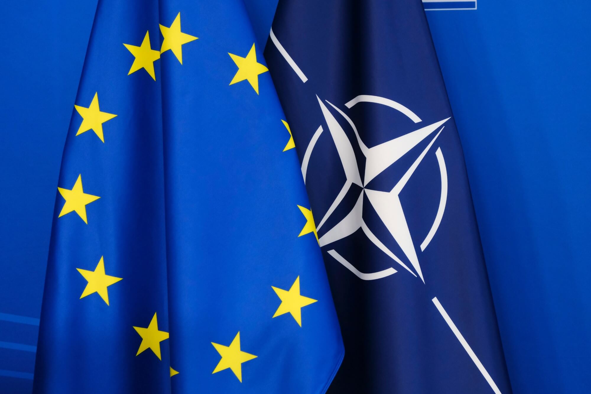 European Union and NATO flags overlapping, symbolizing the cooperation between the EU and NATO